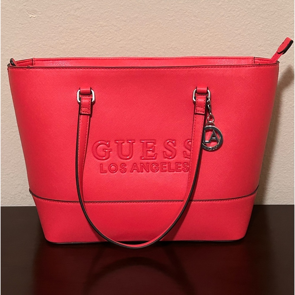 Medium, hot pink Guess tote.  Pocket on the back, 4 additional pockets inside.
